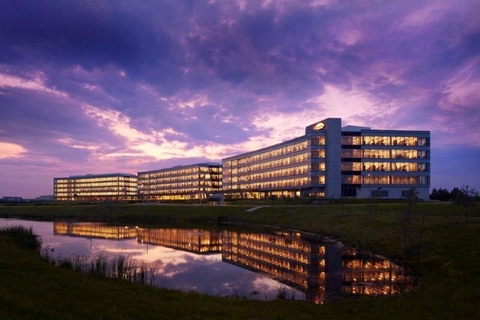 Large office building overlooking water at night