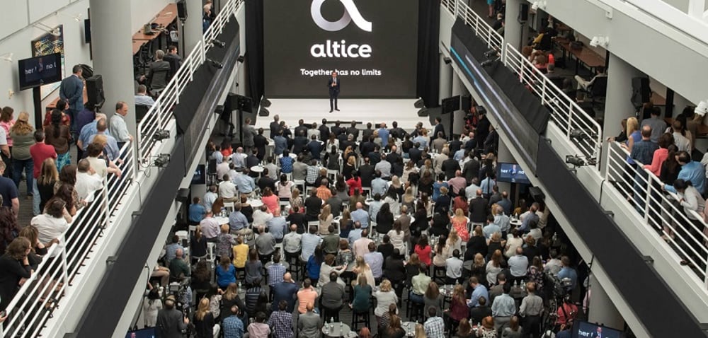 Altice USA logo amid crowd