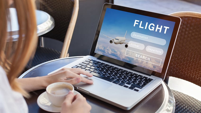 woman searching flights on laptop