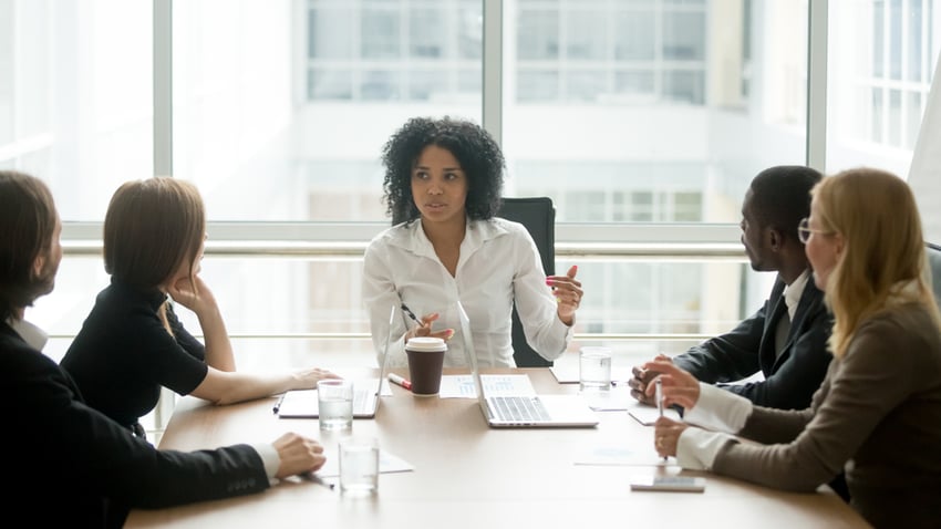 boardroom with woman leading team meeting