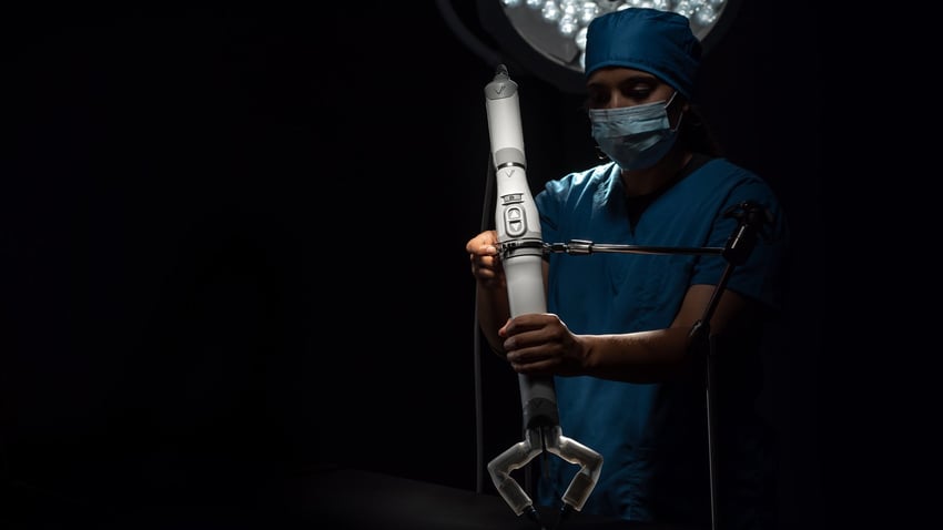 The Mira device clocks in at just two pounds. It’s controlled using the hand controls and foot pedals of the system’s connected surgeon console, which also features a large screen to broadcast a real-time view from the robot’s endoscopic camera. (Virtual Incision)