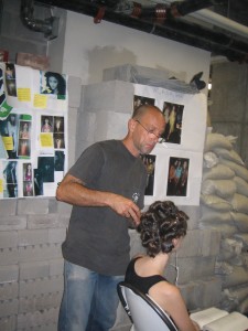 Sebastian Professional lead stylist Thomas Dunkin, styling a model's hair at What Comes Around Goes Around