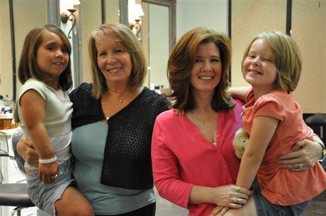 summer-opperud-sandy-vaughn-elaine-hirsch-and-lauren-hirsch Sandy Vaughn (second from left) poses with her daughter Elaine Hirsch (second from right) and granddaughters Summer Opperud and Lauren Hirsch after each donating at least 10 inches of hair at the event.