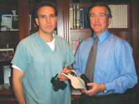  Doctors Lawrence Brown (left) and Bernard Gonik holding a sample of the Tactilus flexible substrate material, part of their research project designed to alleviate back and foot pain in pregnant women. Their proposed solution is to locate and quantify pressure exerted on the soles of the women's feet.  
