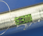 Figure 1. An example of a strain gauge bonded to a sample undergoing tensile-strength testing 