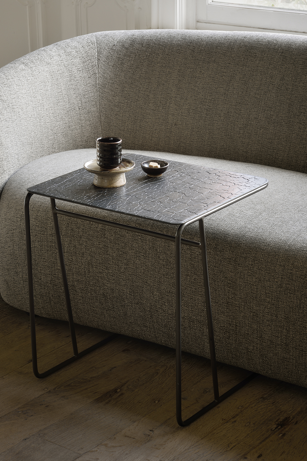 Ethnicrafts Ellipse side table is designed so the bottom can tuck partially under a sofa or bed to save on floor space