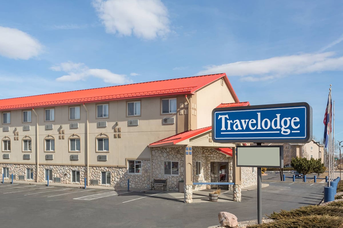 exterior of a hotel building with a Travelodge sign in front of it