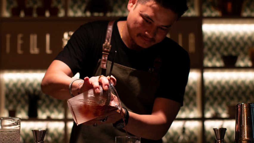Gagan Gurung pours a cocktail at Tell Camellia