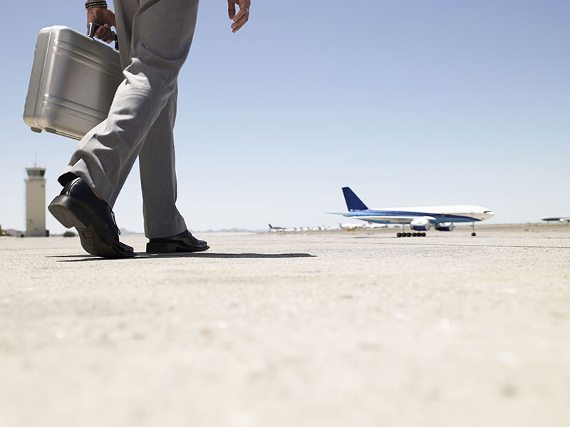 Businessman Walking Toward Airplane