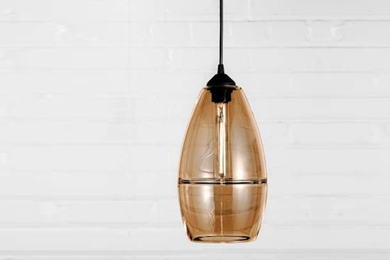 These handcrafted pendants have an interior ring folded into the glass like a halo floating within the shape