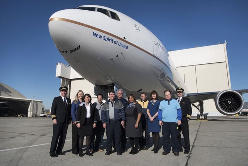 Employees gather under Uniteds new 777-300ER entitled the New Spirit of United
