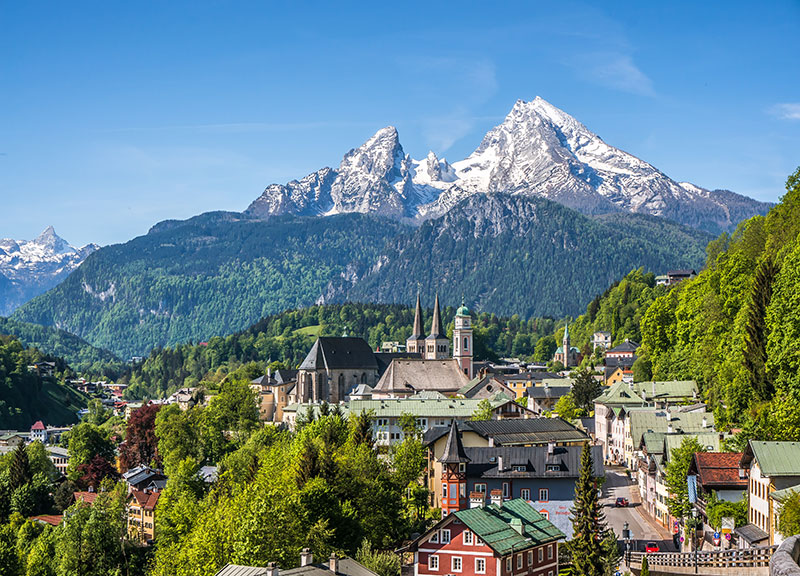 The historic town of Berchtesgaden overlooked by the snowy Watzmann mountain in spring  in Berchtesgadener Land Upper Bavar