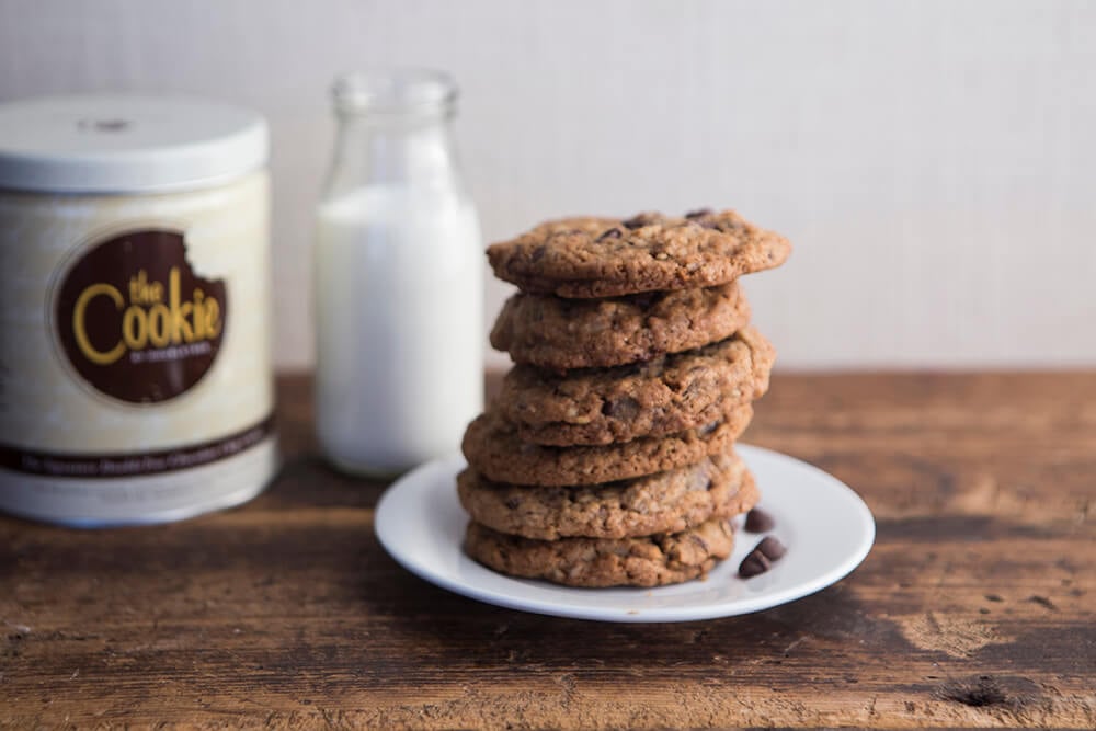 cookies on a plate with a glass of milk