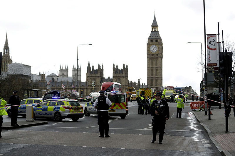 Police secure the area on the south side of Westminster Bridge close to the Houses of Parliament in London