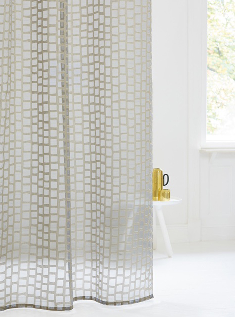 Karneol is a transparent fabric designed with a repeating pattern of slightly irregular rectangles to create an organic motif