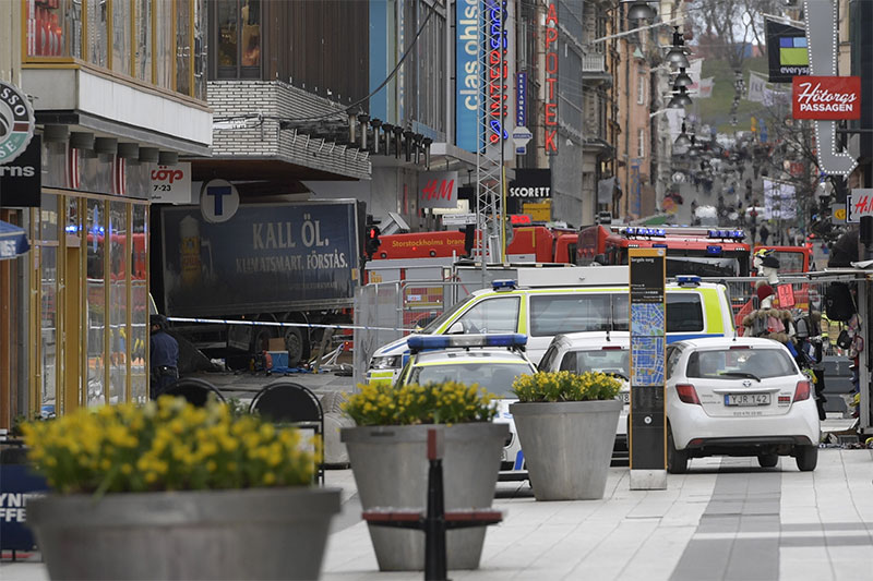 The rear of a truck left protrudes after it crashed into a department store injuring several people in central Stockholm S