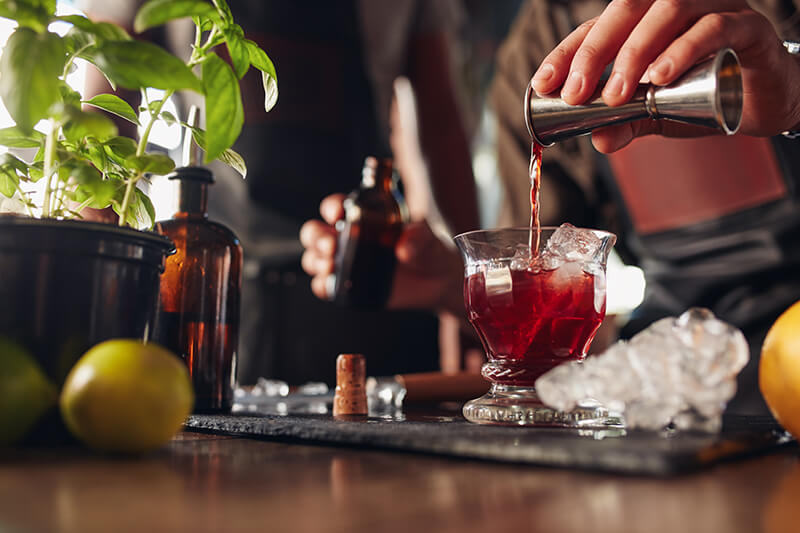 Bartender preparing fresh cocktail behind a bar