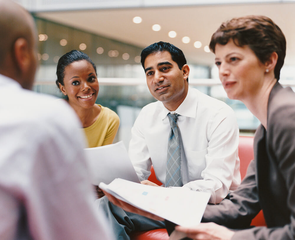 several people sitting around a table talking