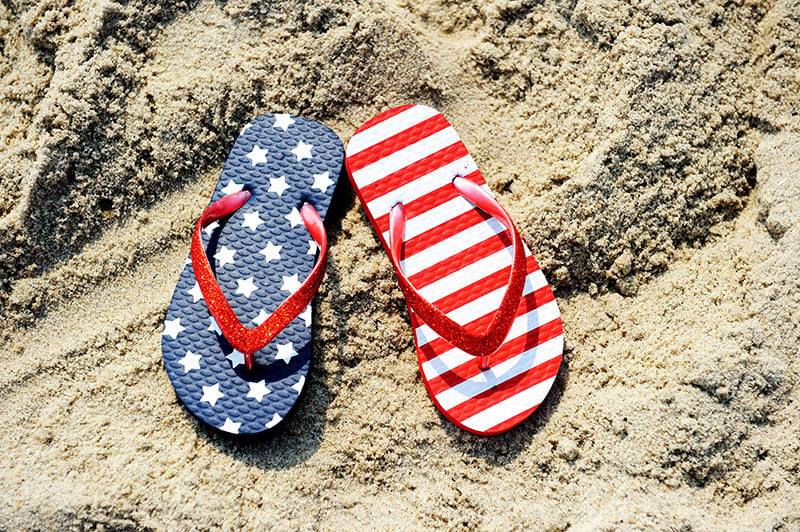 American flag sandals on a beach