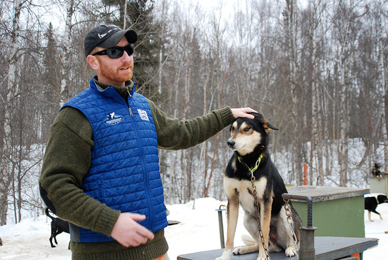 Access Trips Iditarod musher with dog