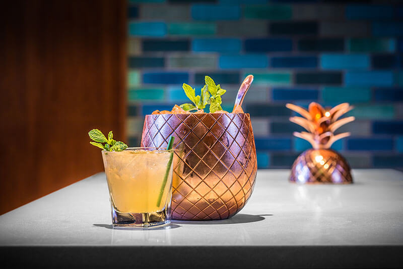 Tuyets Elixer cocktail served in a copper pineapple