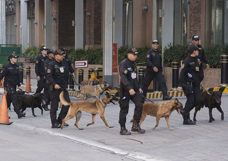 Bomb sniffing dogs walk outside a hotel at the Resorts World Manila complex early Friday June 2 2017 in Manila Philippin