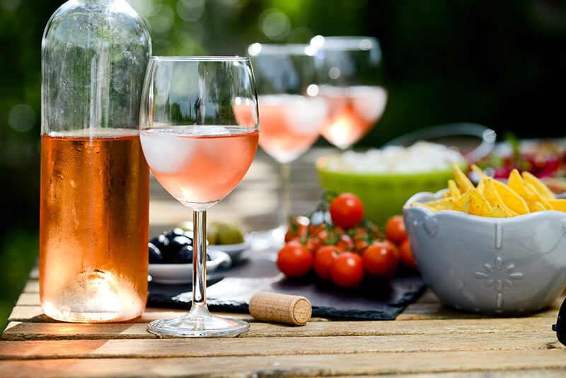rose wine on a table with tomatoes