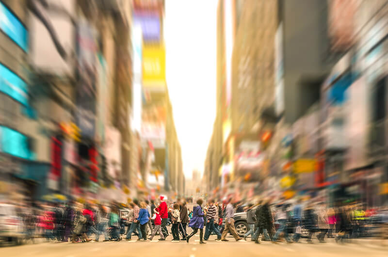 commuters walking across the street in New York City