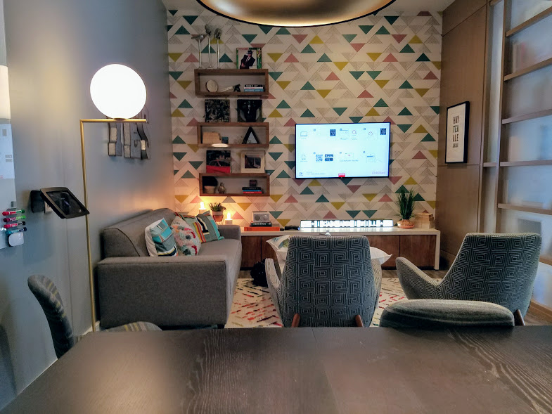 The Crowne Plaza Studio is like a combined living room and dining room with a sofa and a long table