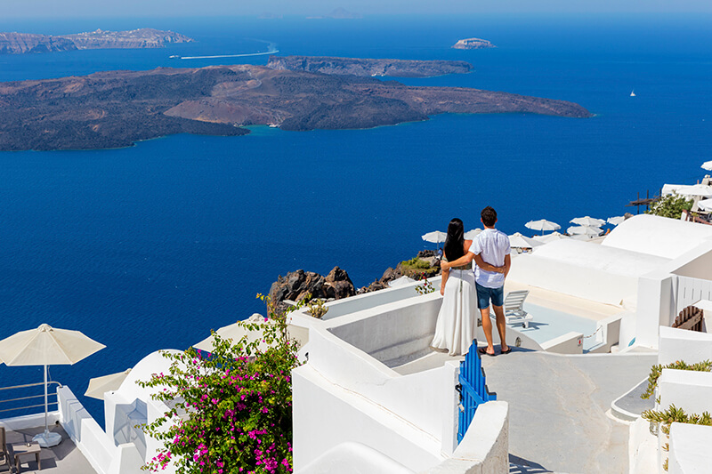 couple in Greece overlooking ocean 