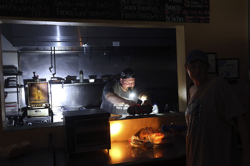 Aaron Howe cooks in the dark kitchen at the Island Convenience Store in Rodanthe on Hatteras Island