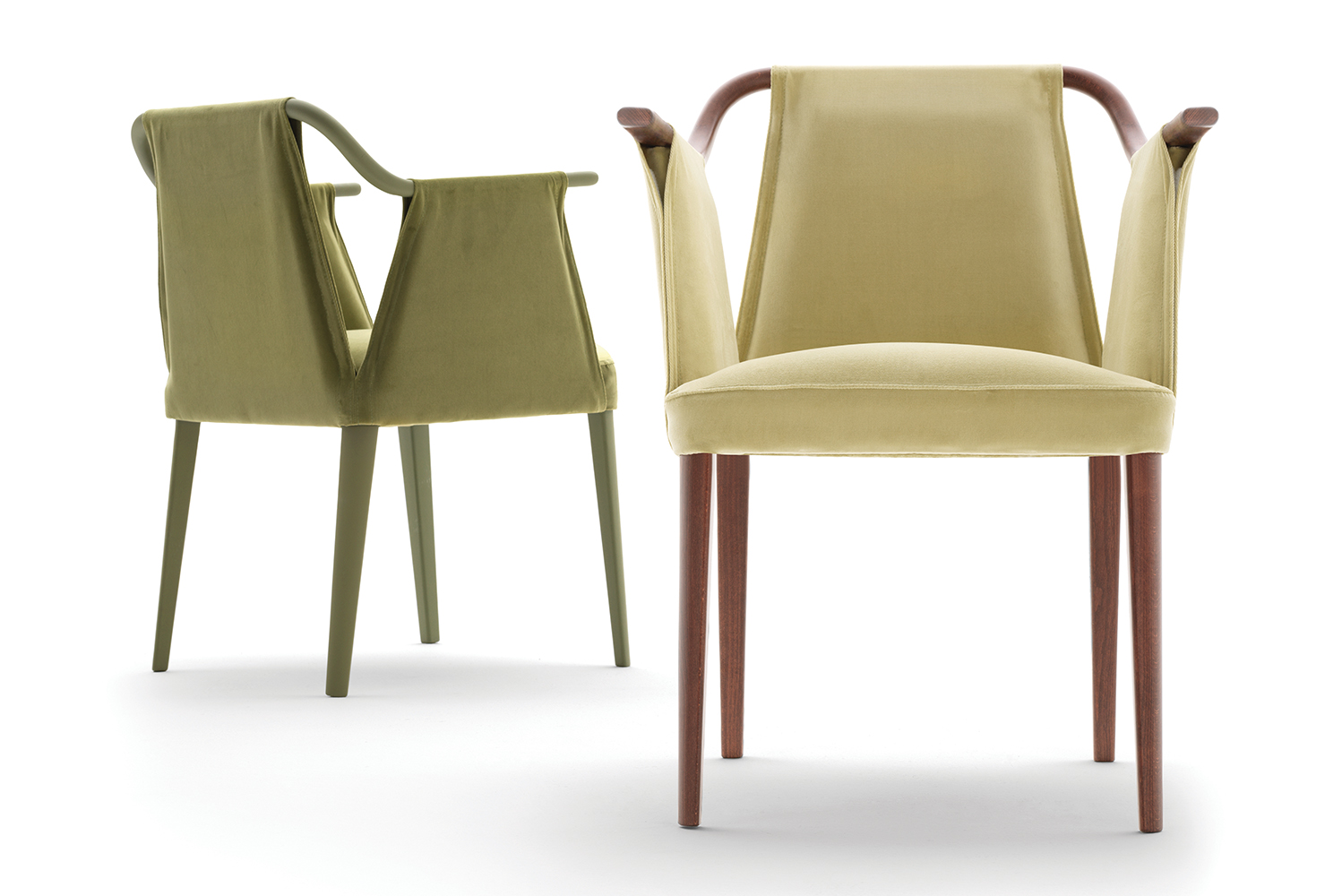 Sayo forms a continuous silhouette since the armchairs upholstery loops through a slender Beech frame to form armrests