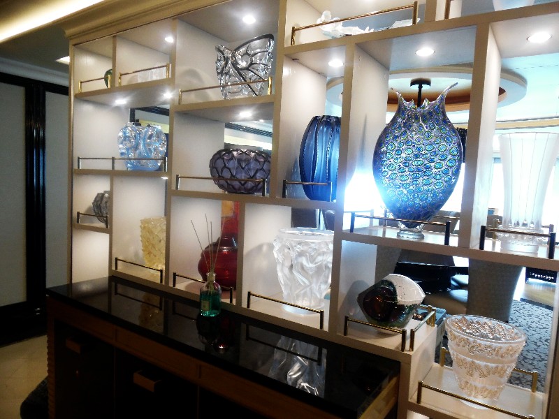 Guests entering the Regent Suite first encounter this stylish credenza displaying creative Murano glass pieces 