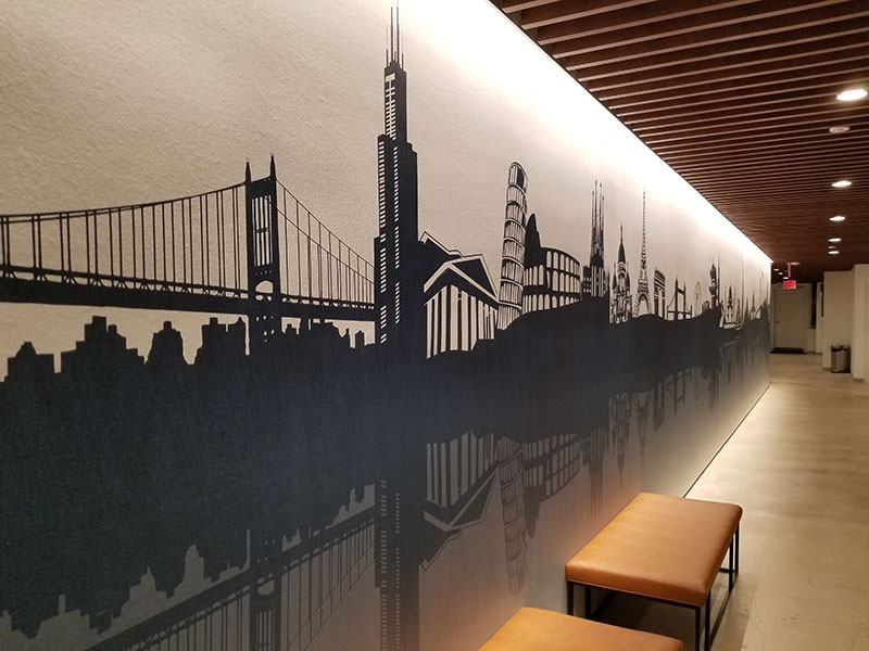 A mural of New York City greets arriving guests