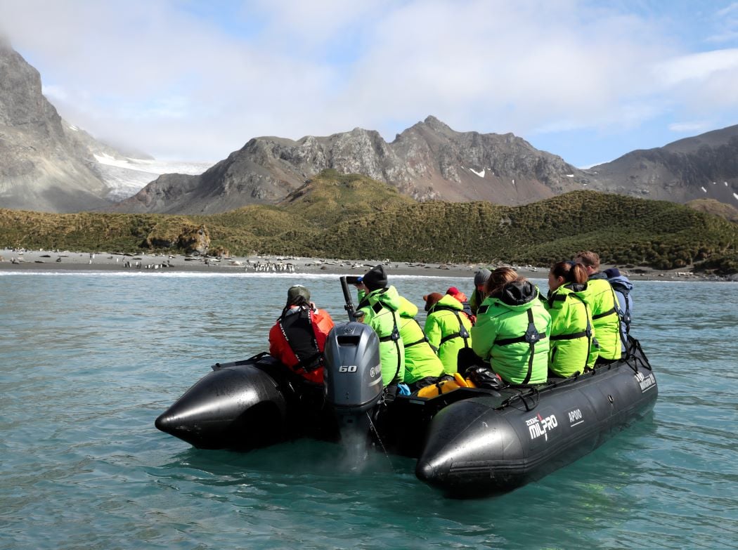 Atlas Ocean Voyages guests take a Zodiac ride at Cooper Bay Antarctica