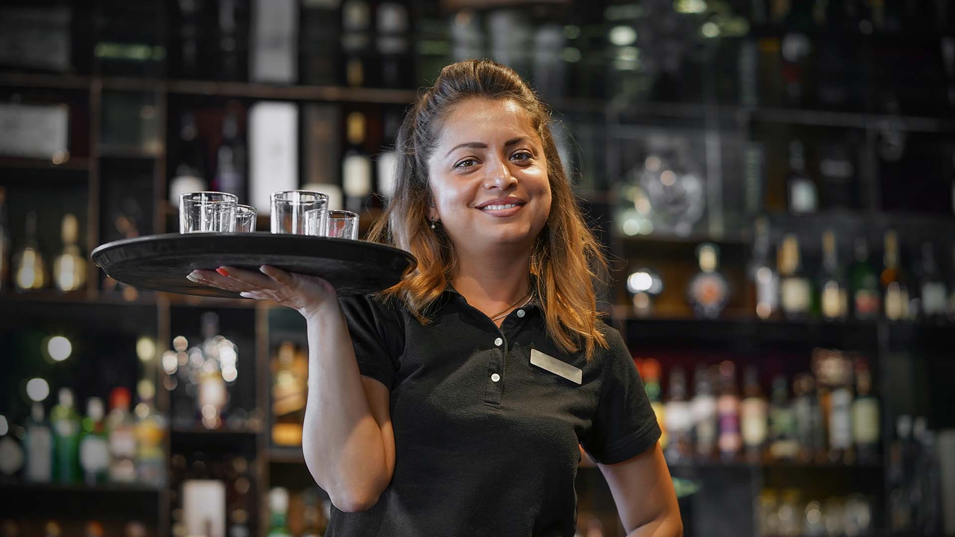 A server smiles in a restaurant