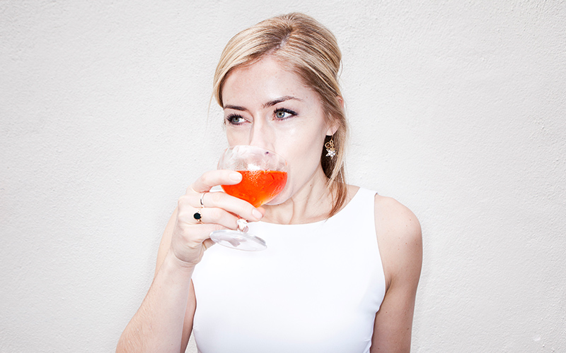 Charlotte Voisey drinks a cocktail