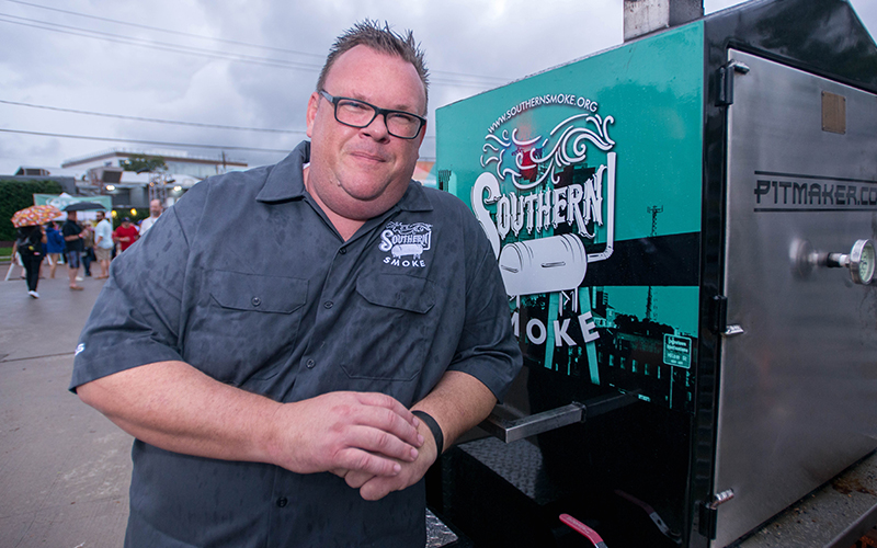 Chef Chris Shepherd stands in front of the Southern Smoke smoker