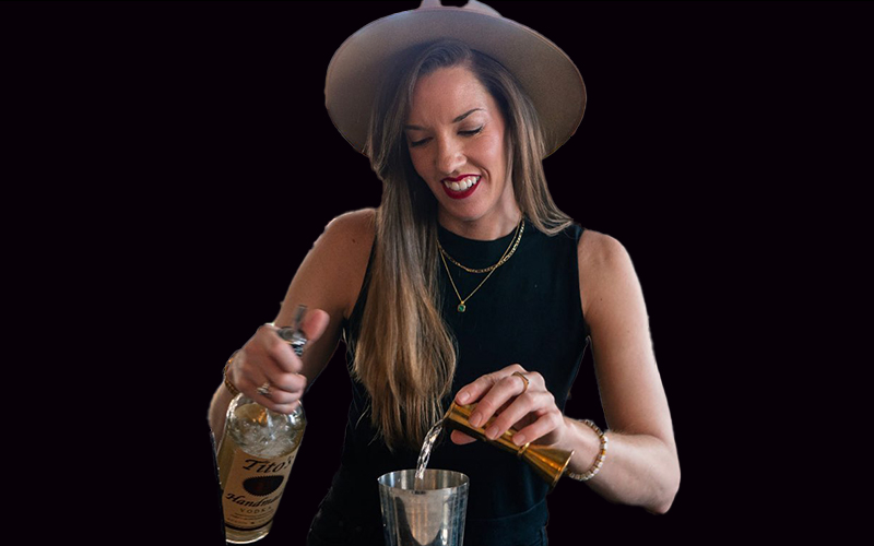 Elissa Dunn pours a shot of vodka into a shaker against a black background