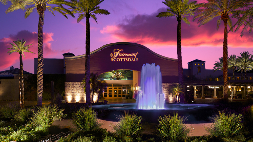 The exterior of the Fairmont Scottsdale Princess with a fountain and palm trees