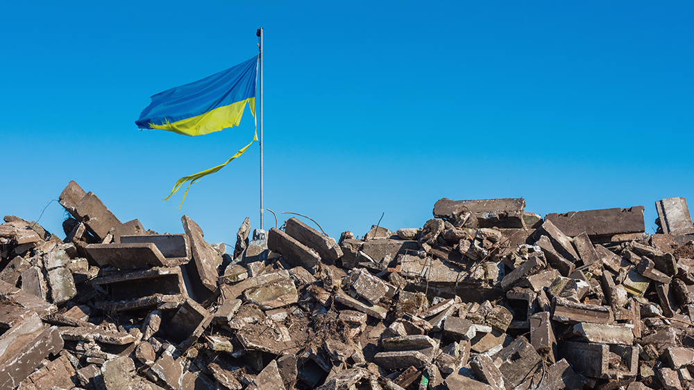 Tattered Ukrainian flag sticking out of rubble