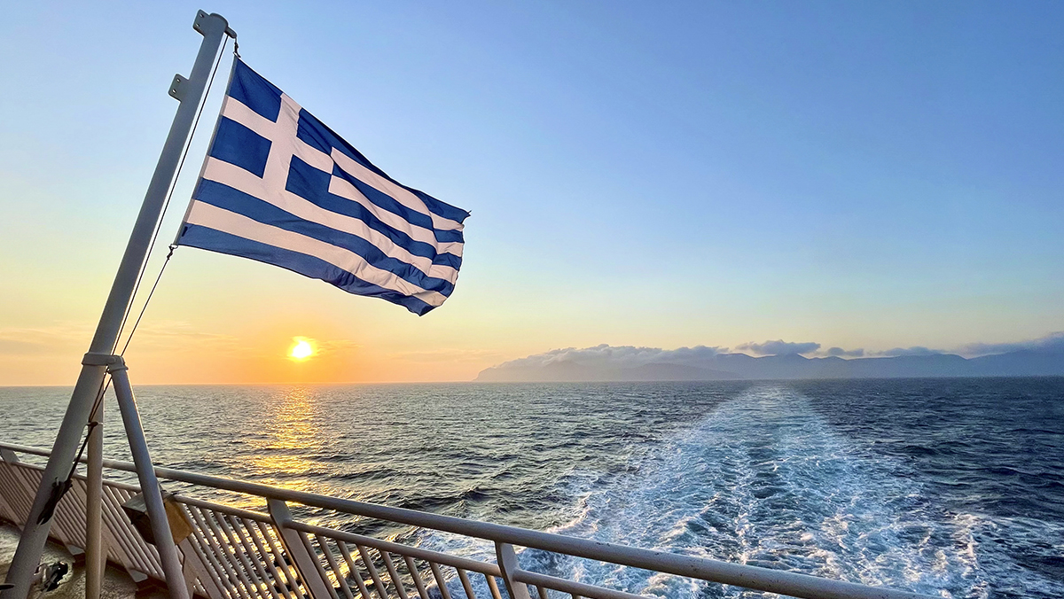 A Greek flag on the back of a boat