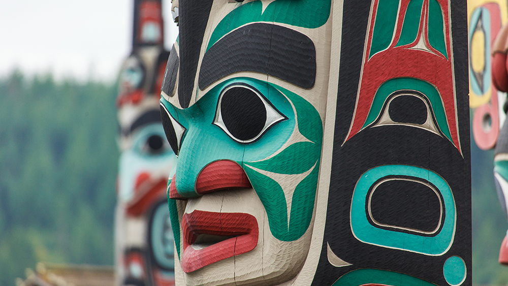 A close up on a face on a totem pole created by Native Alaskans