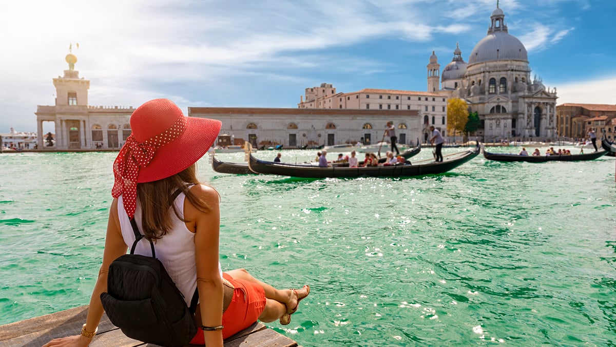 Woman in hat on Grand Canal in Venice Italy