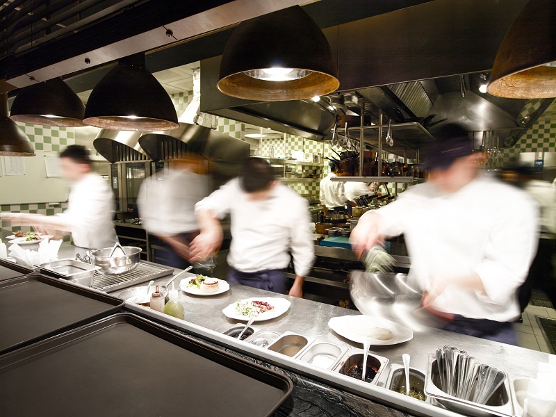Busy chefs work in a restaurant kitchen 
