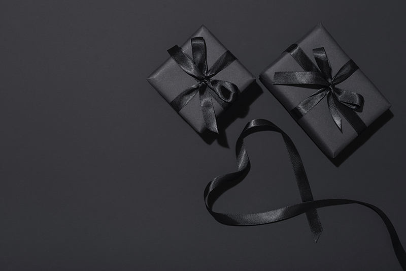 two gifts wrapped in black 