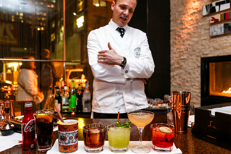 Bartender Angus Winchester with cocktails