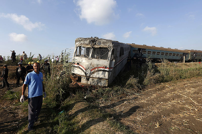 Onlookers gather at the scene of a train collision just outside Egypts Mediterranean port city of Alexandria
