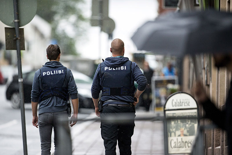 Armed police officers secure the area after several people were stabbed on the Market Square in Turku Finland