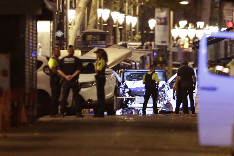 Police officers stand next to the van involved on an attack in Las Ramblas in Barcelona Spain